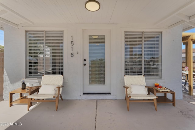 property entrance with stucco siding
