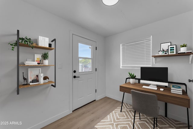 home office with baseboards and wood finished floors