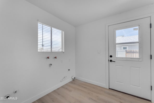 clothes washing area featuring light wood-style floors, hookup for an electric dryer, laundry area, and hookup for a gas dryer