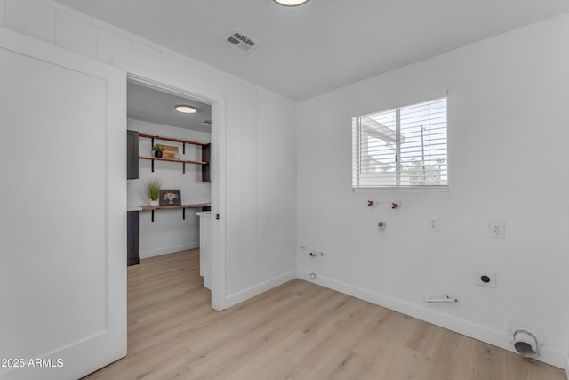 interior space with baseboards, visible vents, and light wood finished floors