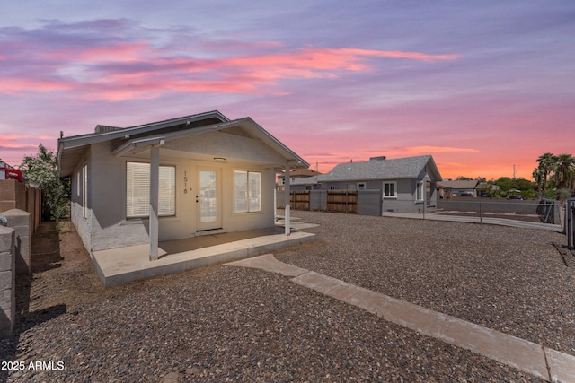 view of front facade featuring a fenced backyard and a patio area