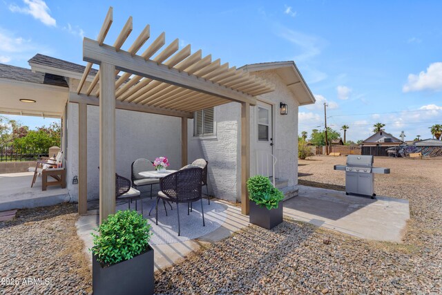 view of patio / terrace with area for grilling, a pergola, and fence