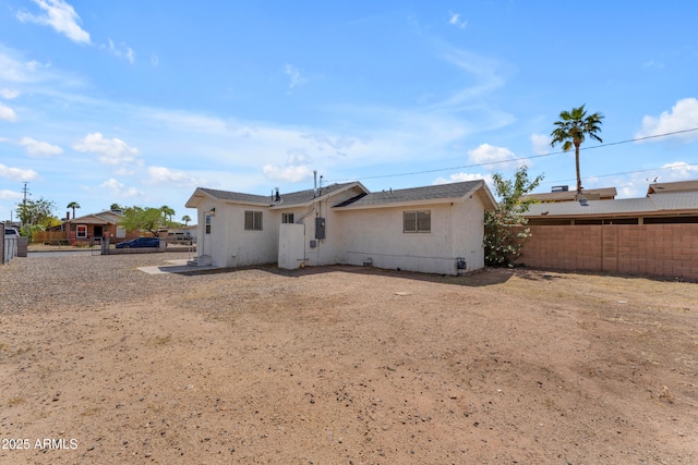 rear view of house with fence