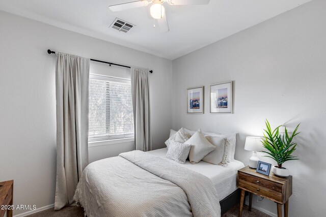 carpeted bedroom with visible vents, a ceiling fan, and baseboards