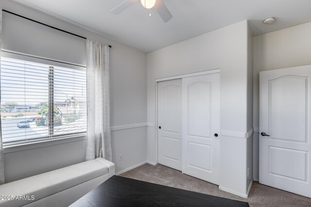 unfurnished room with baseboards, ceiling fan, and carpet flooring