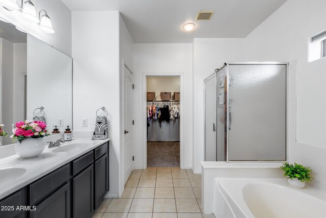 full bath with visible vents, tile patterned flooring, a bath, a shower stall, and a sink