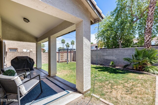 exterior space with grilling area and a fenced backyard
