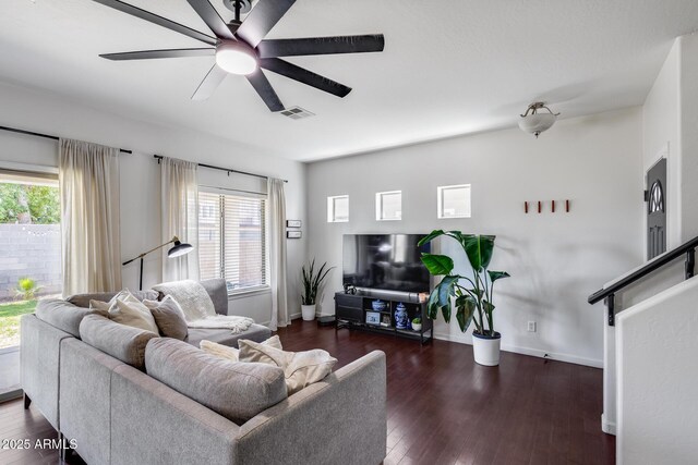 living area featuring plenty of natural light, a ceiling fan, wood finished floors, and visible vents