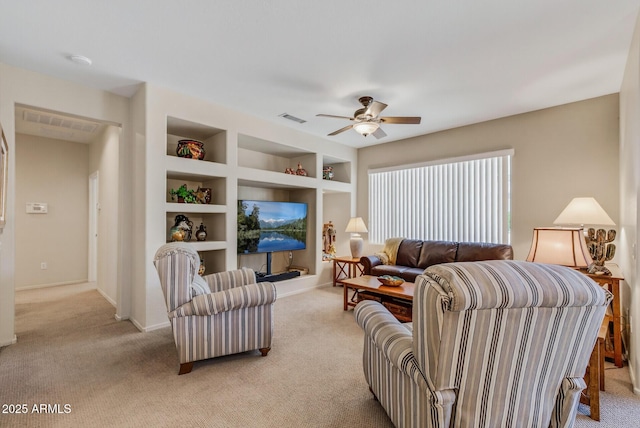 16412 W Peppertree Ct, Surprise, AZ 85387 - living room featuring light colored carpet, a ceiling fan, and built in shelves