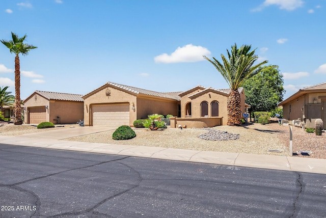 16412 W Peppertree Ct, Surprise, AZ 85387 - mediterranean / spanish-style home with an attached garage, stucco siding, driveway, and a tiled roof