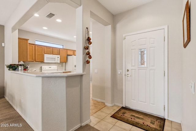 16412 W Peppertree Ct, Surprise, AZ 85387 - kitchen with white appliances, light countertops, a peninsula, recessed lighting, and light tile patterned floors