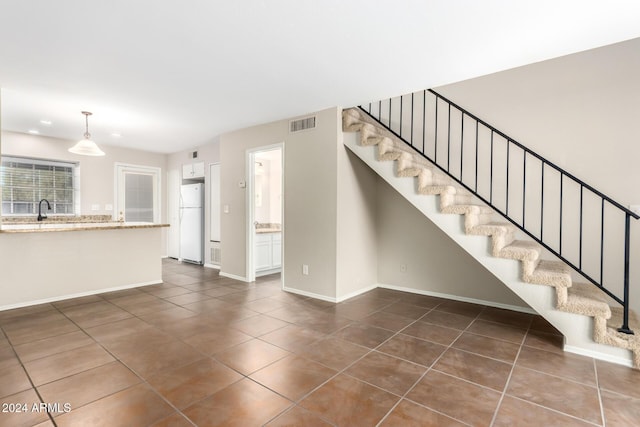 interior space featuring tile patterned flooring and sink