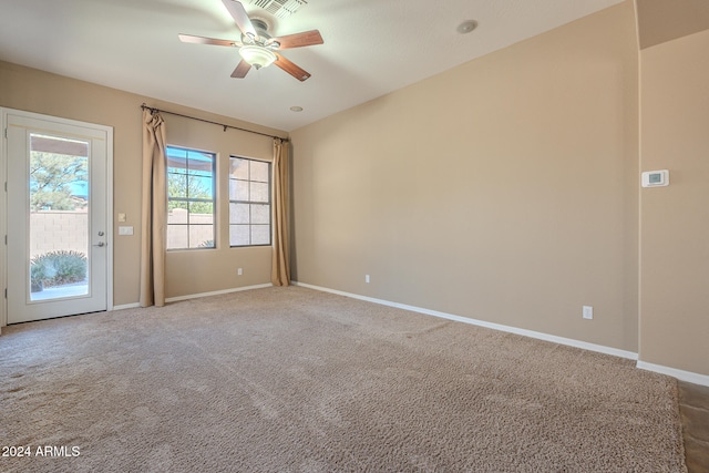 empty room with ceiling fan and carpet floors