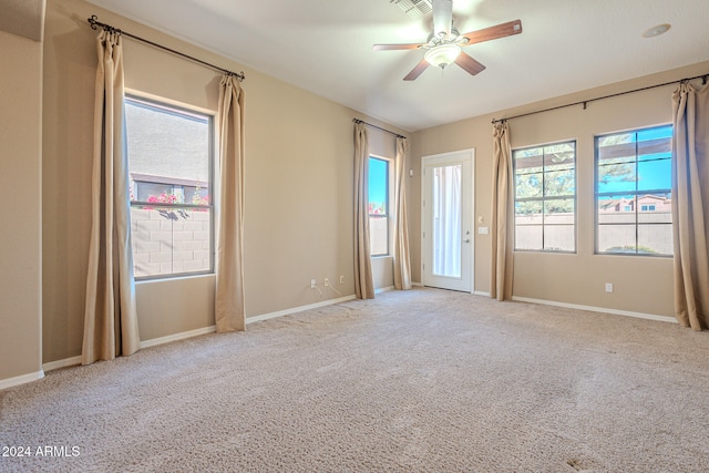 spare room featuring ceiling fan and light carpet