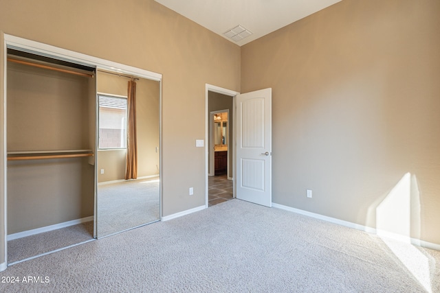 unfurnished bedroom with carpet floors and a closet