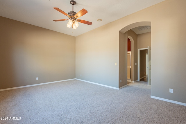 empty room with ceiling fan and light carpet