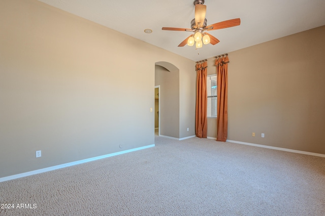 carpeted spare room with ceiling fan