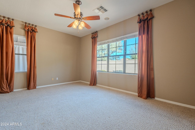 carpeted spare room featuring ceiling fan