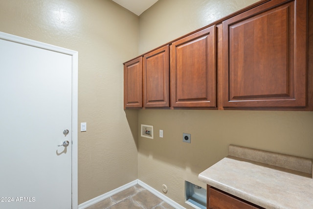 washroom with cabinets, hookup for an electric dryer, hookup for a gas dryer, hookup for a washing machine, and light tile patterned floors