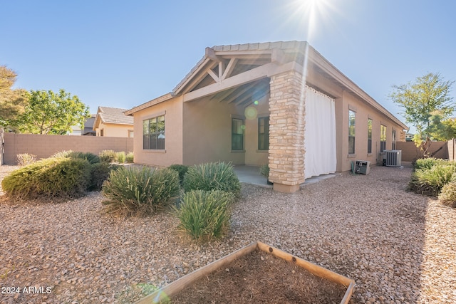 view of home's exterior with a patio and central AC