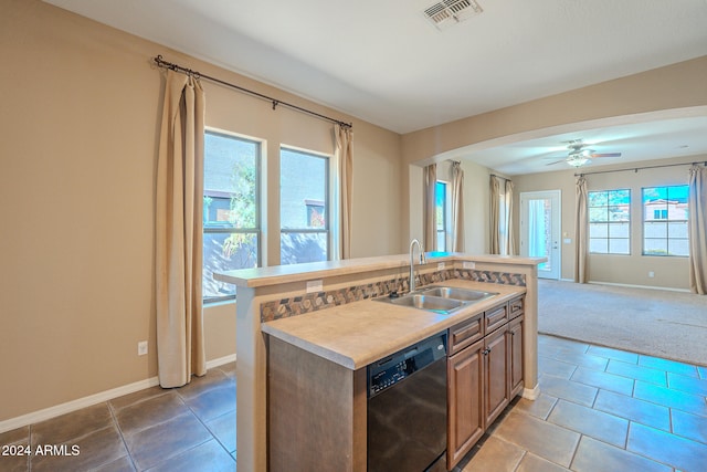 kitchen featuring dishwasher, a kitchen island with sink, sink, tile patterned flooring, and ceiling fan