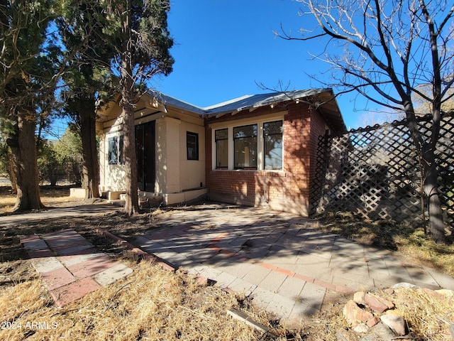 rear view of property featuring a patio area