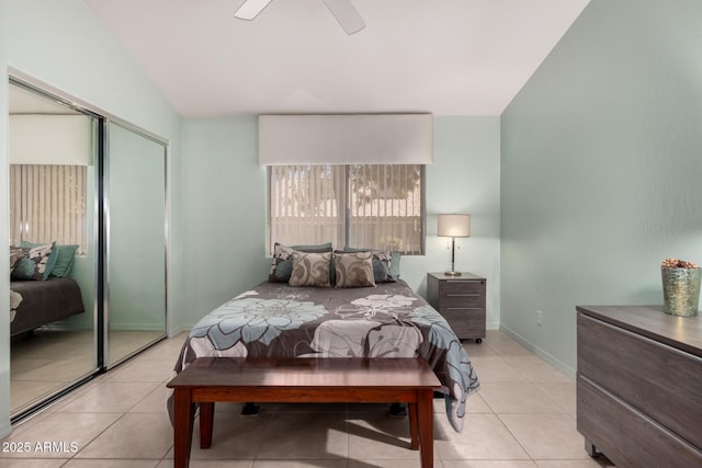 5830 E Mckellips Rd Unit 120, Mesa, AZ 85215 - bedroom with vaulted ceiling, light tile patterned floors, a closet, baseboards, and a ceiling fan