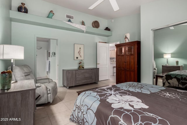 5830 E Mckellips Rd Unit 120, Mesa, AZ 85215 - bedroom with light tile patterned floors, a ceiling fan, and ensuite bathroom