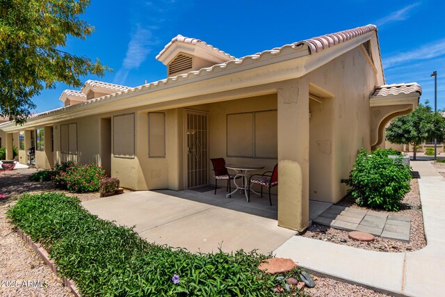 5830 E Mckellips Rd Unit 120, Mesa, AZ 85215 - rear view of house with a tiled roof, a patio area, and stucco siding