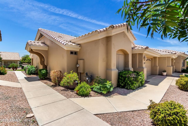5830 E Mckellips Rd Unit 120, Mesa, AZ 85215 - view of property exterior with an attached garage, stucco siding, and a tiled roof