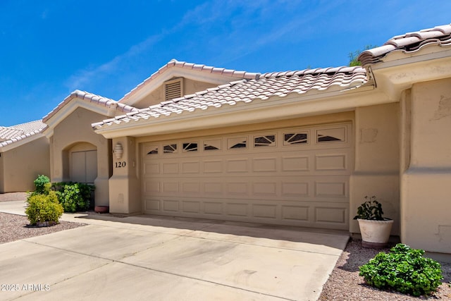 5830 E Mckellips Rd Unit 120, Mesa, AZ 85215 - view of front of home featuring driveway, a garage, stucco siding, and a tiled roof