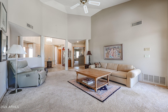 carpeted living room with plenty of natural light, ceiling fan, and high vaulted ceiling