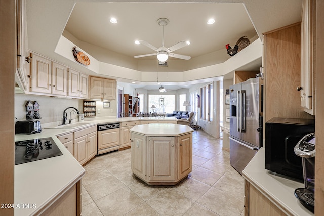 kitchen with a center island, black appliances, sink, light tile patterned floors, and kitchen peninsula