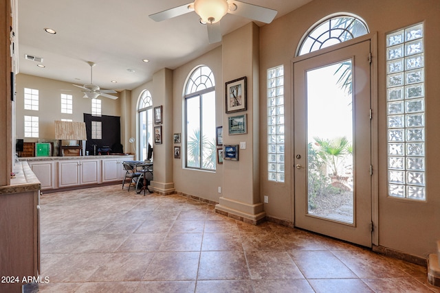 foyer entrance featuring ornate columns and ceiling fan