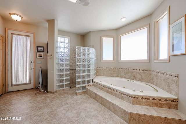 bathroom featuring tile patterned flooring and independent shower and bath