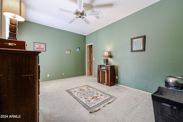 interior space featuring ceiling fan and light colored carpet