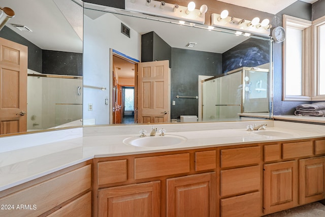 bathroom featuring vanity, toilet, and a shower with shower door