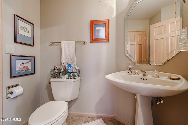 bathroom with tile patterned floors, sink, and toilet