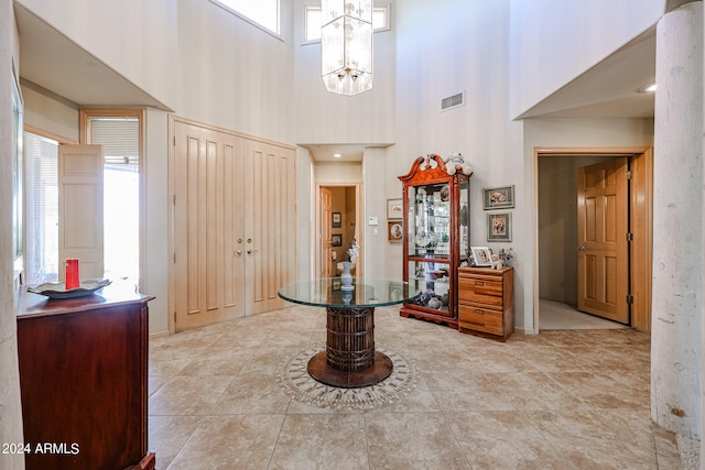 entryway featuring a high ceiling and a notable chandelier