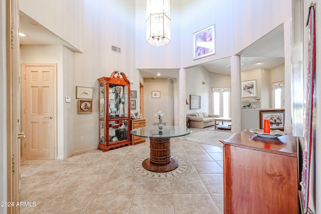 tiled foyer entrance with a towering ceiling