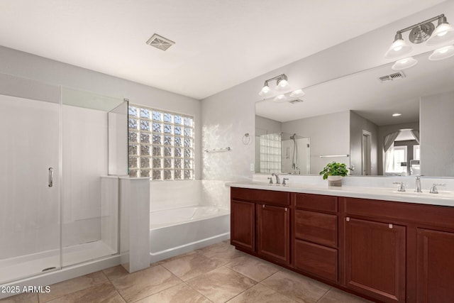 bathroom featuring vanity, tile patterned floors, and shower with separate bathtub