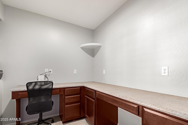 office featuring built in desk and vaulted ceiling