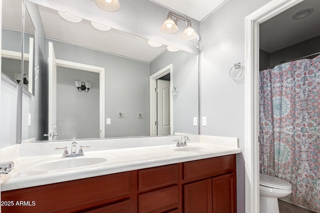 bathroom featuring vanity, curtained shower, and toilet