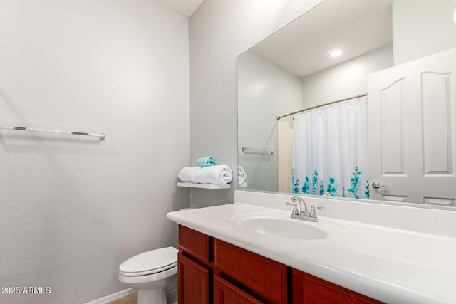 bathroom with vanity, a shower with curtain, and toilet