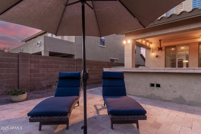 view of patio terrace at dusk