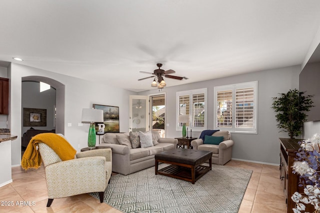 tiled living room with ceiling fan