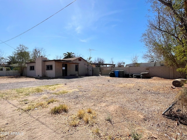 rear view of property with fence