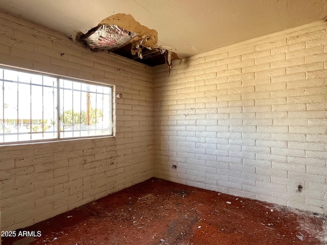 spare room with brick wall