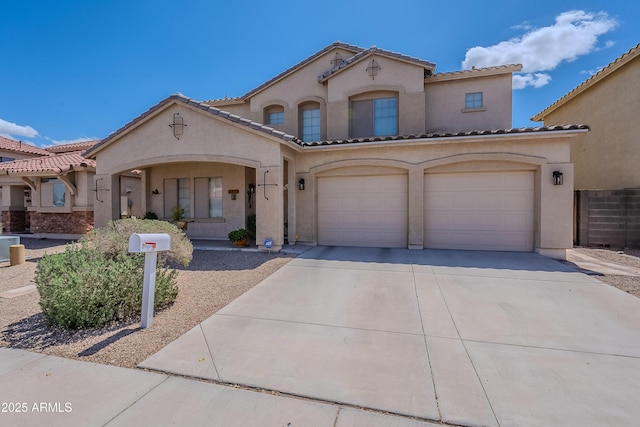 mediterranean / spanish-style house featuring stucco siding, a tile roof, concrete driveway, and a garage