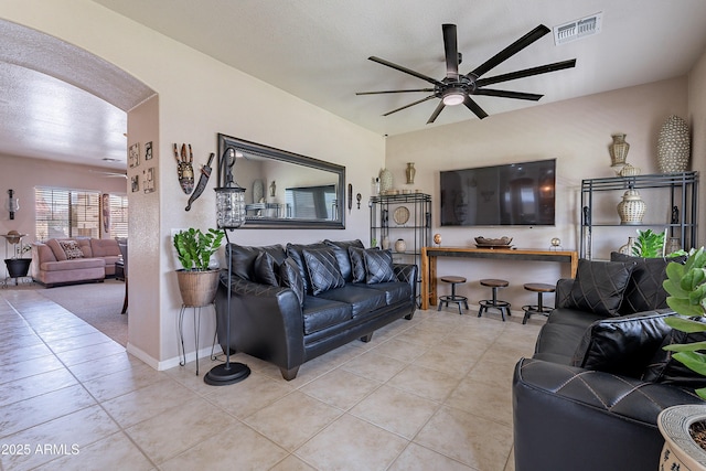 living area with visible vents, ceiling fan, and light tile patterned flooring
